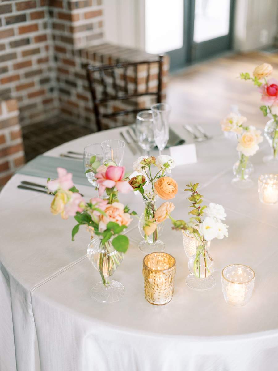 Gold mercury tealights and glass tealight holders on sweetheart table